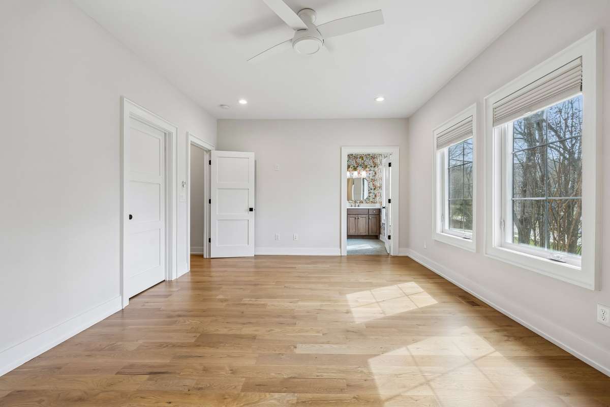 First floor oversized guest suite features generously sized walk-in closet, en suite that rivals the primary bathroom with soaking tub/shower combo and beautiful views of the front lawn.