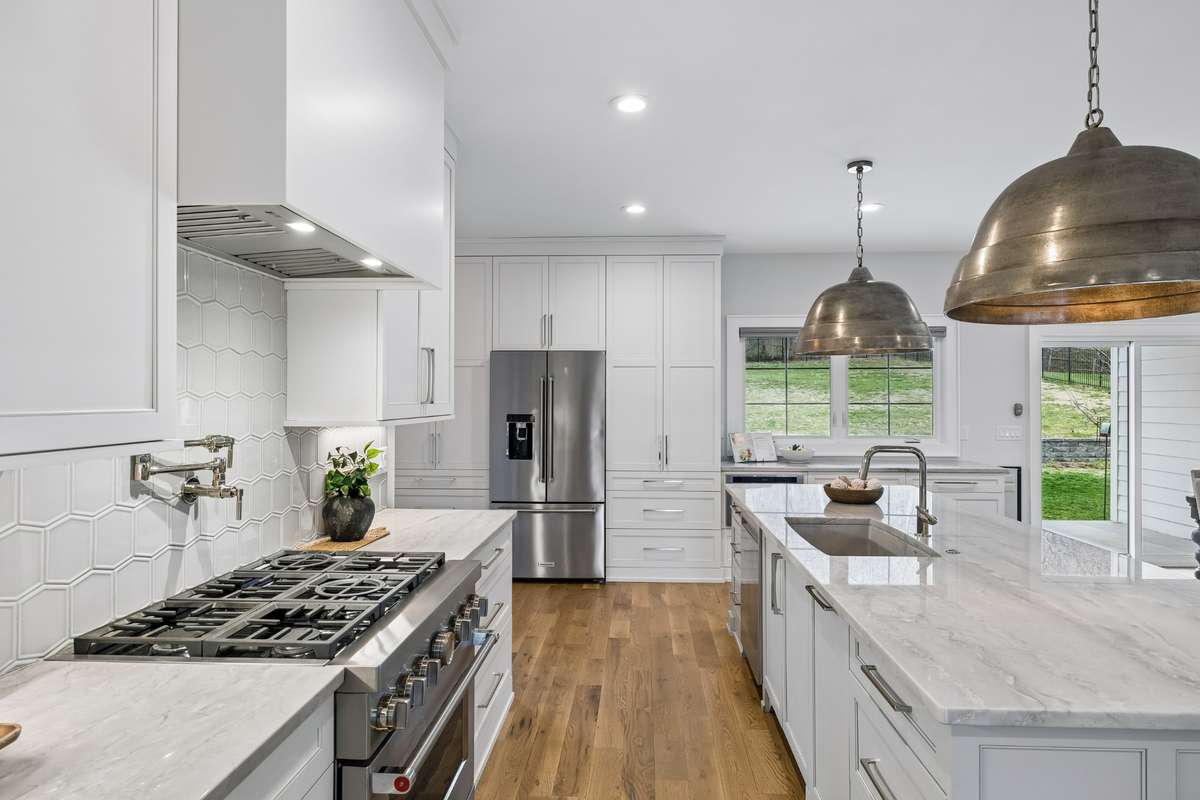 The kitchen features a gas range along with thoughtfully chosen designer finishes.