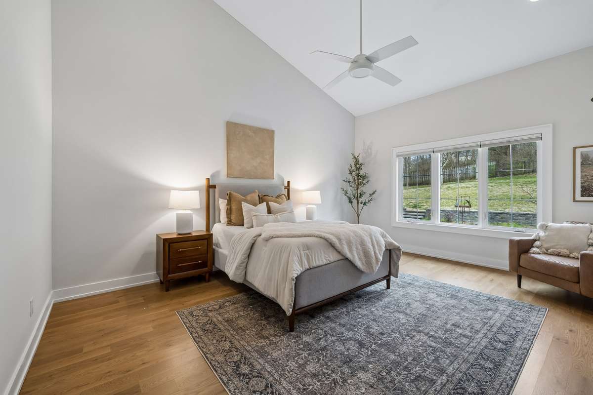 First floor primary suite blends beautifully into en-suite bathroom and custom walk-in closet which is cleverly placed as a thru-way to the first floor laundry room.
