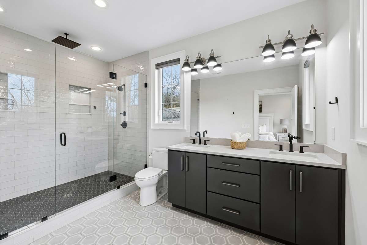 Second floor primary bathroom features double vanity that boasts extra storage opportunities and sizable walk-in shower.