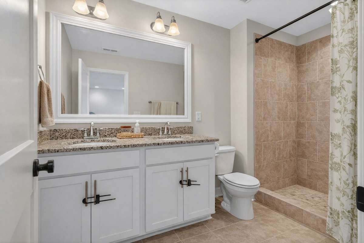 Dual vanity primary bath with tile shower