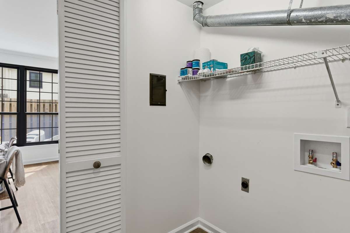 Laundry is in fully closet with storage.