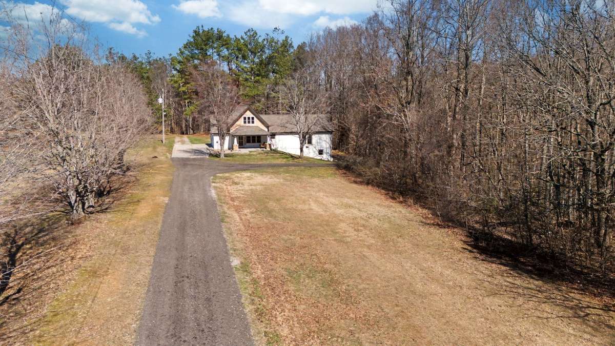 Concrete Parking Pad at the Home but Long Driveway is Gravel