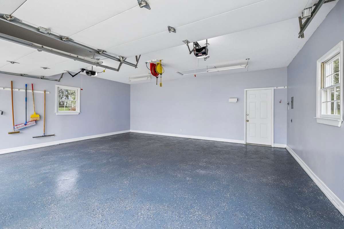 Detached 2 Car Garage with Epoxy Floors and Workshop Area that is heated/cooled in the back of garage,
