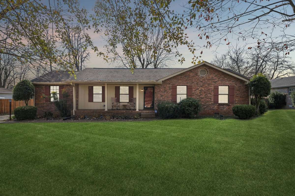 Classic brick ranch on a spacious level lot with mature trees, welcoming curb appeal in a peaceful, established neighborhood.