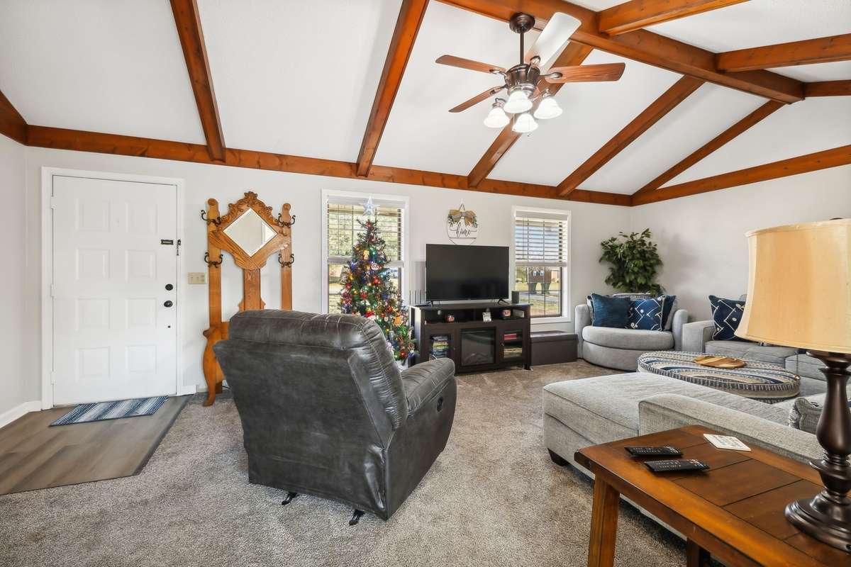 Another angle showcasing exposed beams, neutral tones, and a flexible layout.