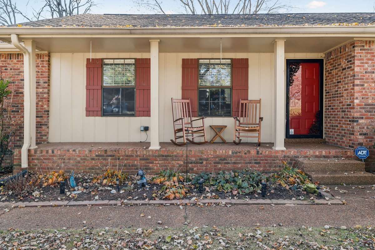 Charming front elevation with a rocking chair porch, perfect for morning coffee or evening relaxation.
