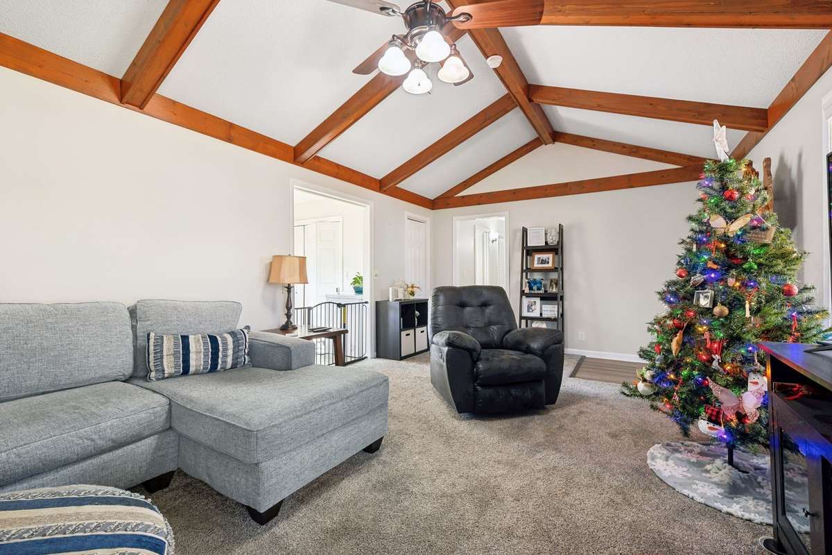 Another angle showcasing exposed beams, neutral tones, and a flexible layout.