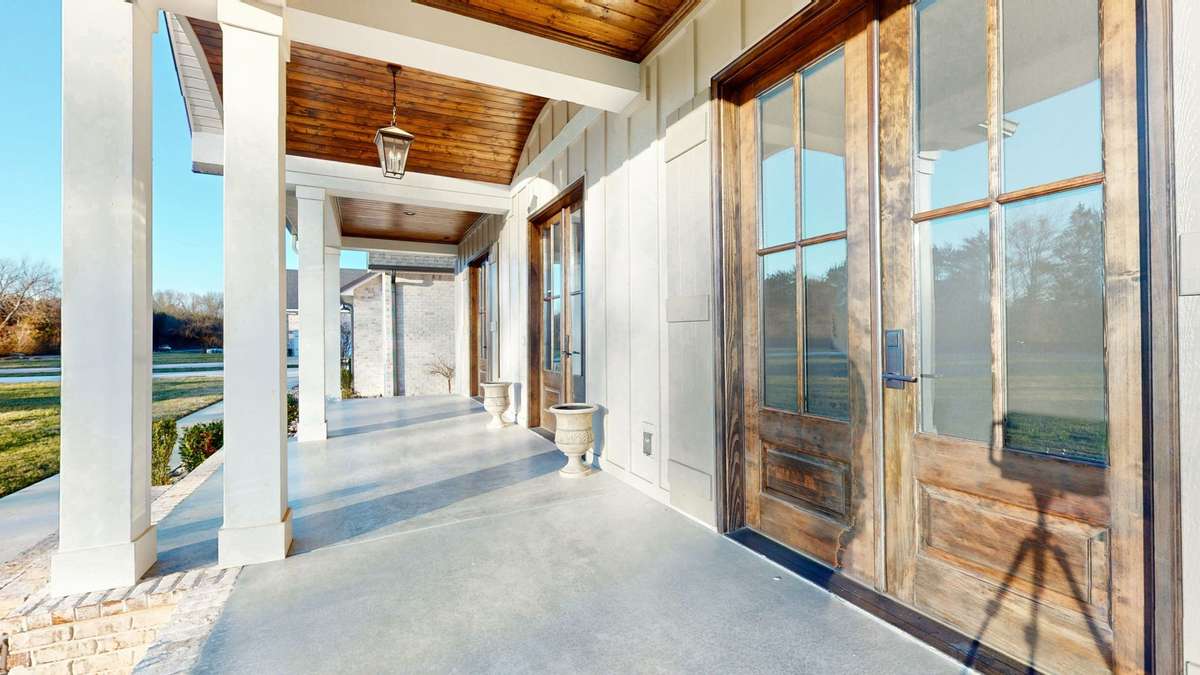 Huge covered porch with custom ceilings.