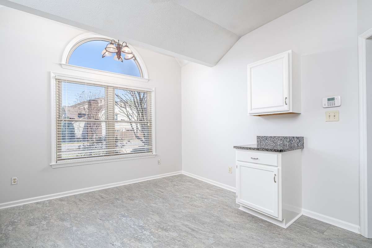 Eat in area in the Kitchen with large window for plenty of sunshine that leads upward to the vaulted ceiling