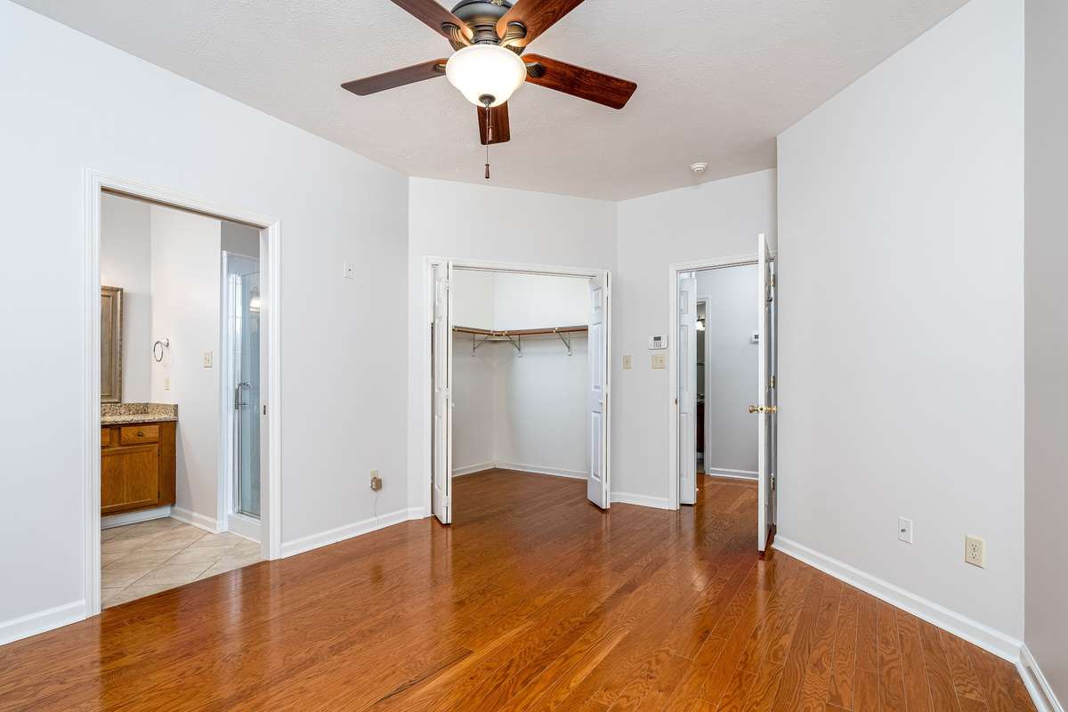 Primary Suite located on the main level with a walk in closet and Hardwood floors