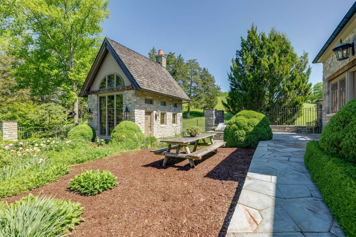Picnic table, cold frame boxes, a fountain, and gazebo too