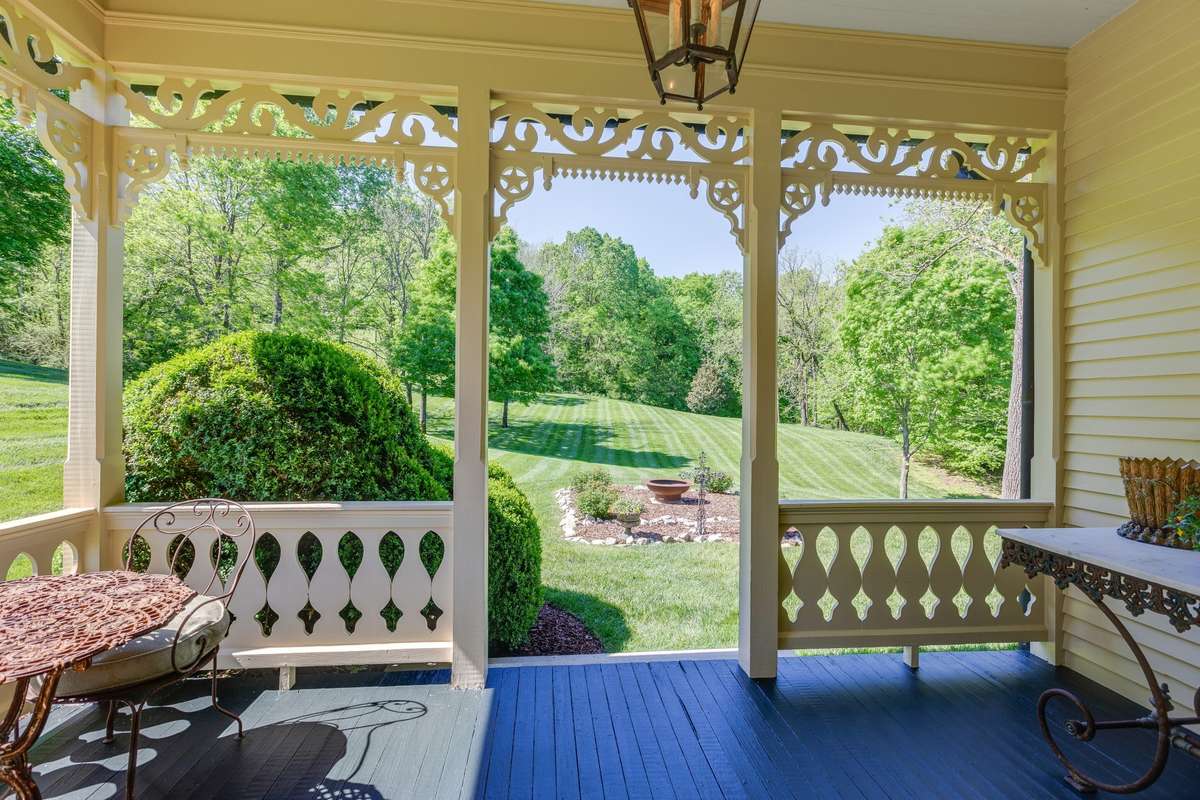 Covered porches offer exquisite millwork detail, and great farm views
