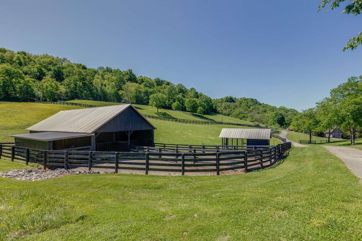 The back barn has two stalls with auto water, and temperature controlled fans, run in area, fenced dog run, concrete floor equipment storage area, and chicken coop