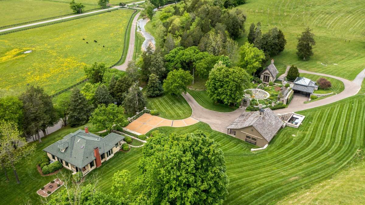 Luxury compound featuring fully restored country cottage, formal garden with masonry library and one-of-a-kind greenhouse, and fine horse barn