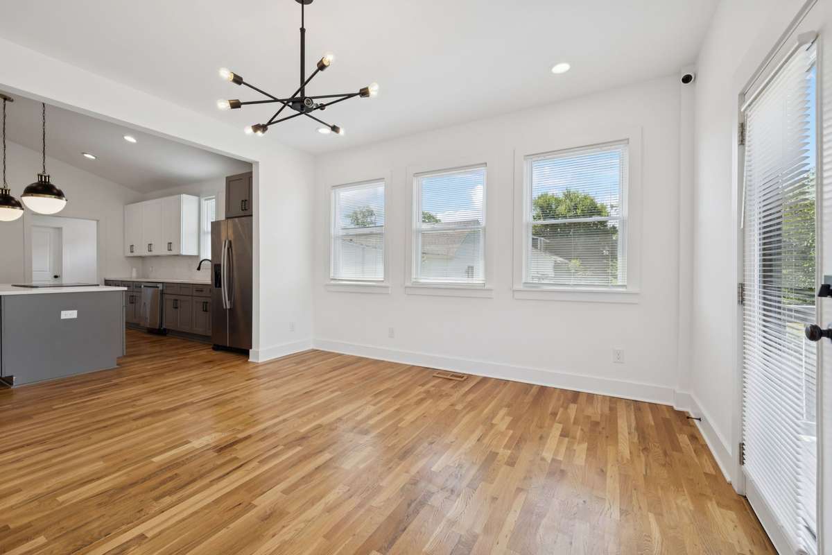 This photo features the living room that is open to the kitchen.