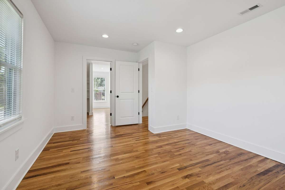 This is the third bedroom, located upstairs.  The room dimensions are 13x12.  In the background of the photo is the door to the large walk-in closet.
