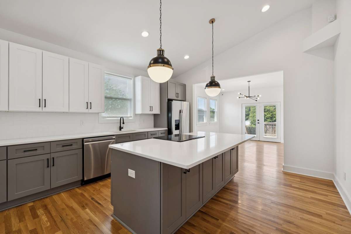 The heart of your home is this new kitchen - featuring new stainless steel appliances, glowingly beautiful light fixtures, and space for people to gather around the island.