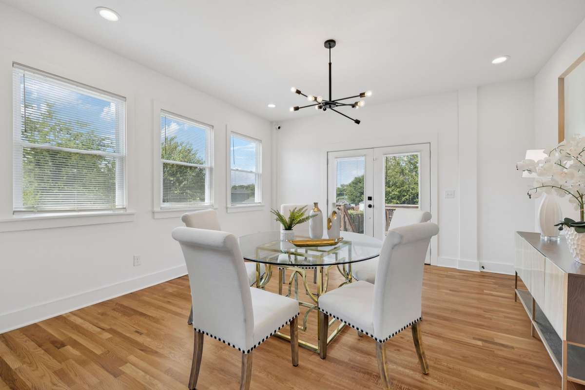 This photo features the space that is open to the kitchen.  However, it's virtually staged as a dining area.  The French doors lead to the back deck.