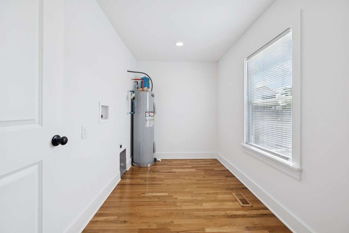This expansive utility room contains the washer/dryer hookup.  The dimensions are 11x6 - giving you ample room for customizations with shelving, racks, etc.  Just outside of this room is a door that opens to the side yard.