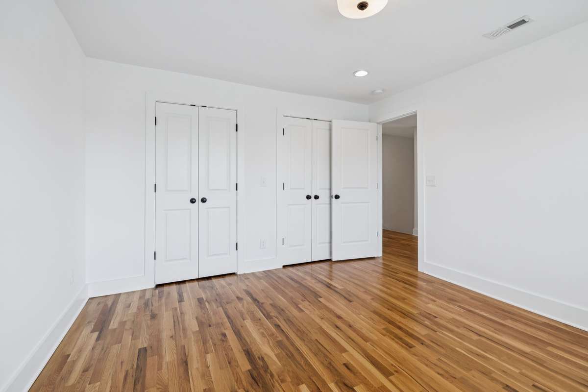 This is bedroom #4, located on the second floor.  It's 16x11 and features two sets of double doors that open to a large closet.