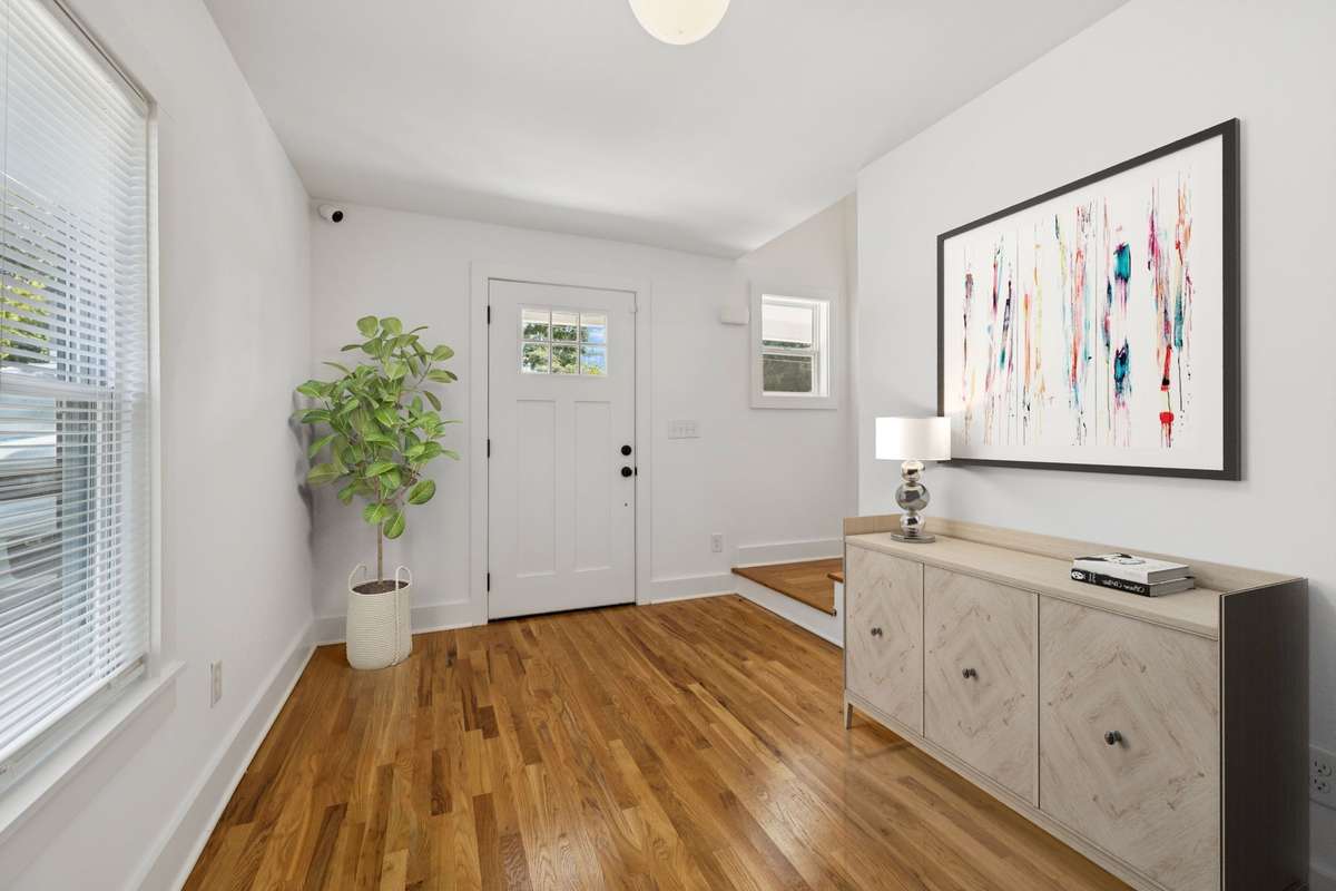 This photo features the front entry.  It has been virtually staged.