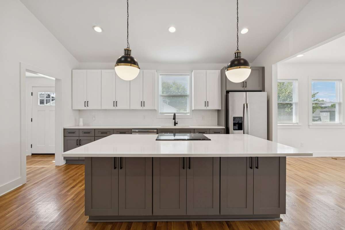 To the right is the living room, and to the left is the expansive walk-in pantry room, the utility room, and a door that leads to the the side yard
