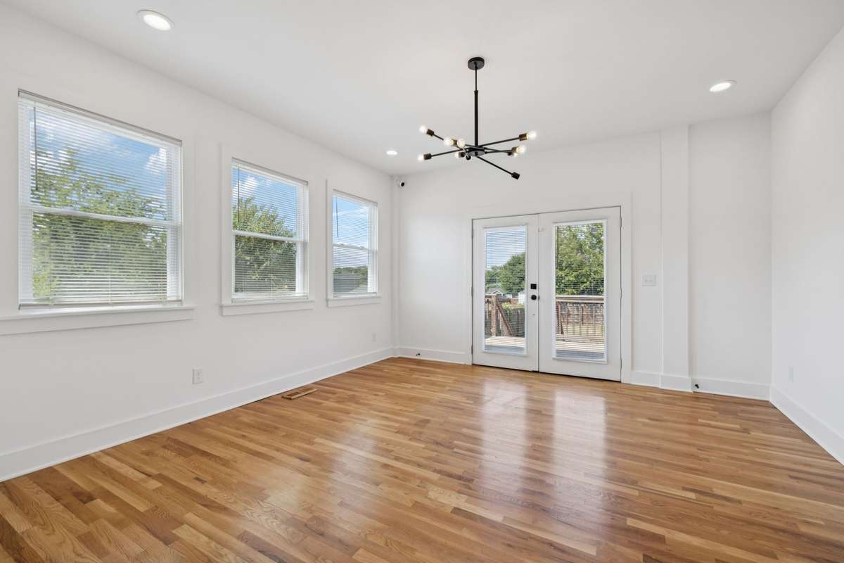 This photo features the living room that is open to the kitchen.  The French doors lead to the back deck.