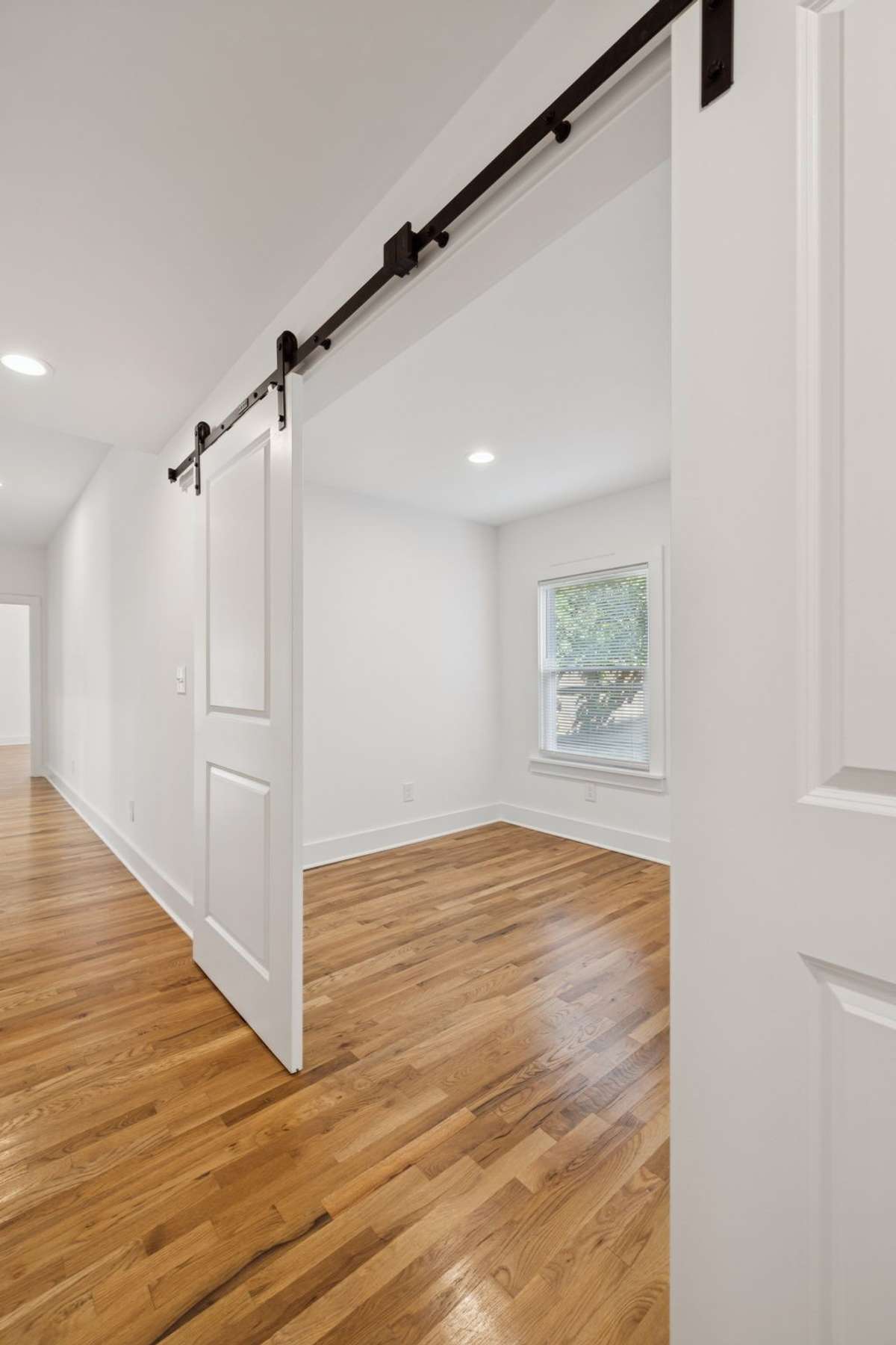 The flex space's barn doors provide privacy.