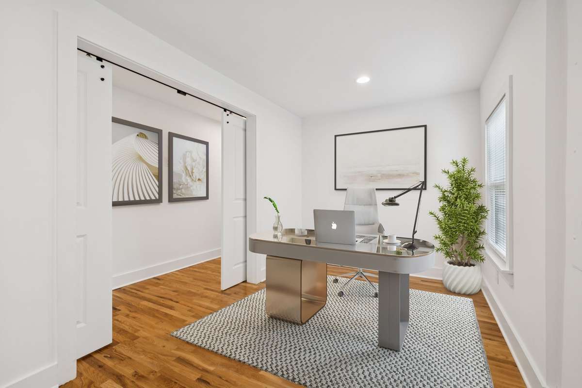 This flex space can be used as a home office.  The barn doors allow for privacy. The room has been virtually staged.