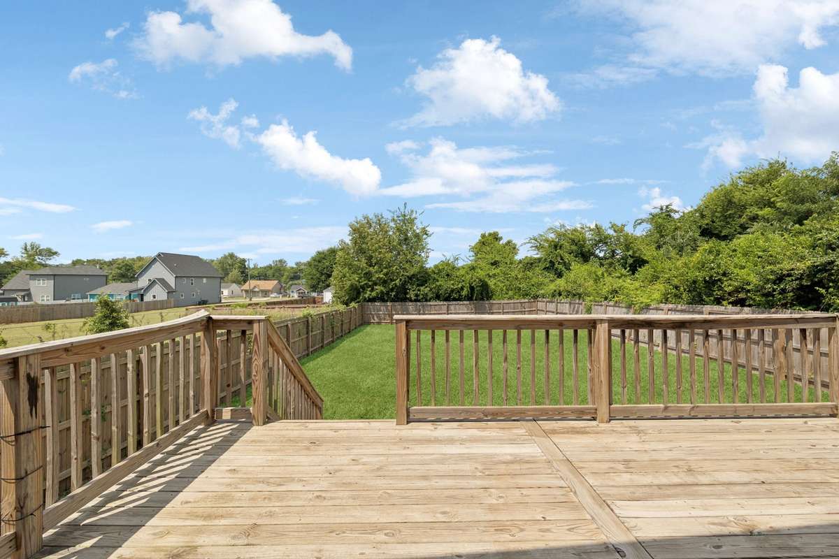 The living room's French doors open to this deck - giving you outdoor-living options.  The deck opens to your large fully-enclosed back yard.