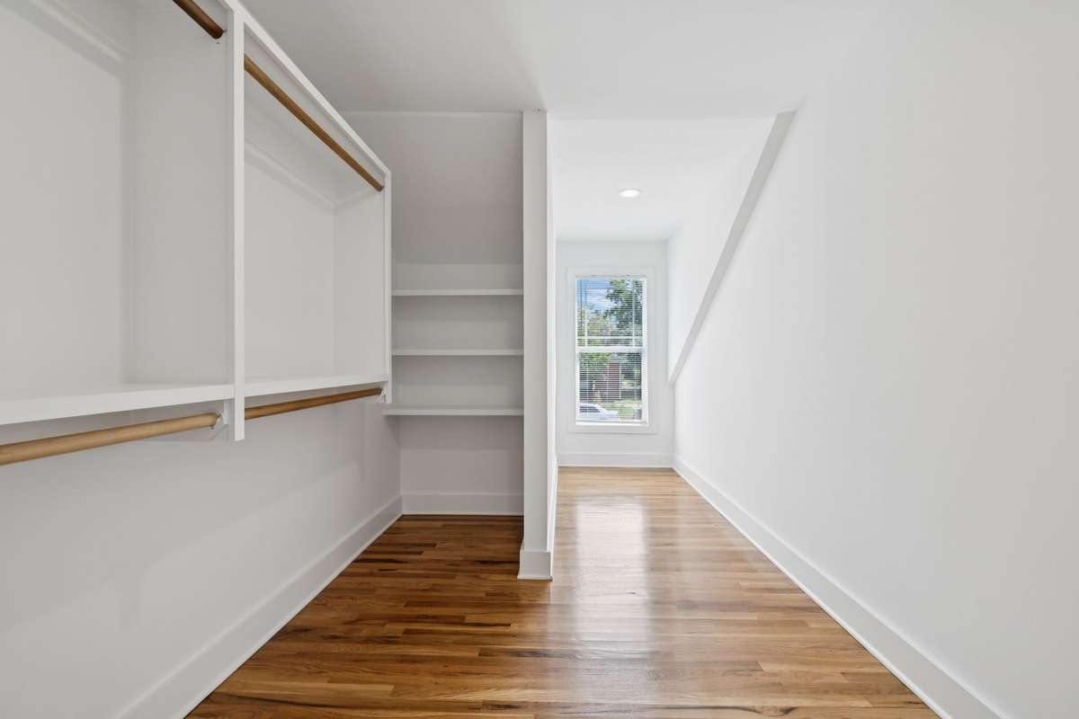 This is the large walk-in closet that's in the 3rd bedroom.  It features built-in shelving and hanging racks.