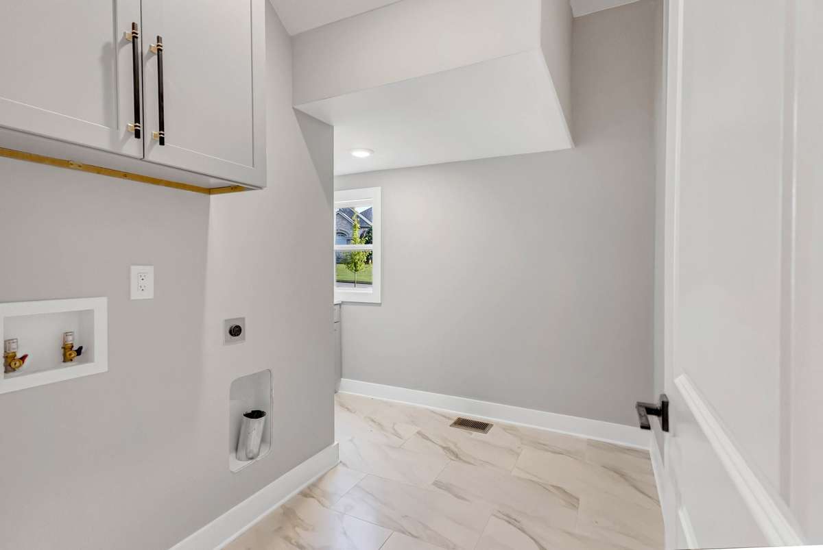 The laundry room provides plenty of storage