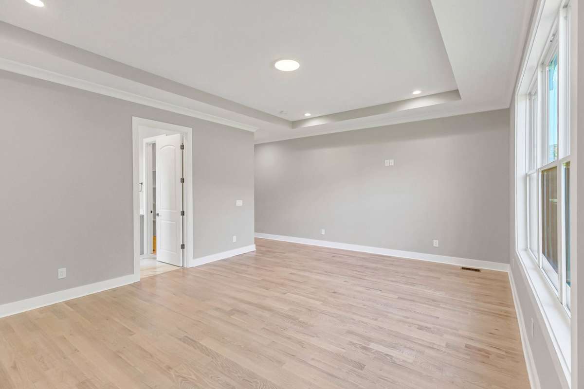 tray ceilings add a designer touch to the primary bedroom