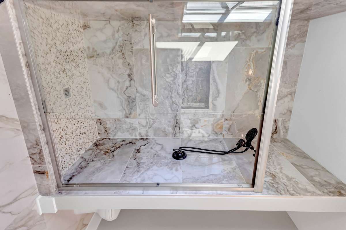 and another MASSIVE shower with floor to ceiling tiles!