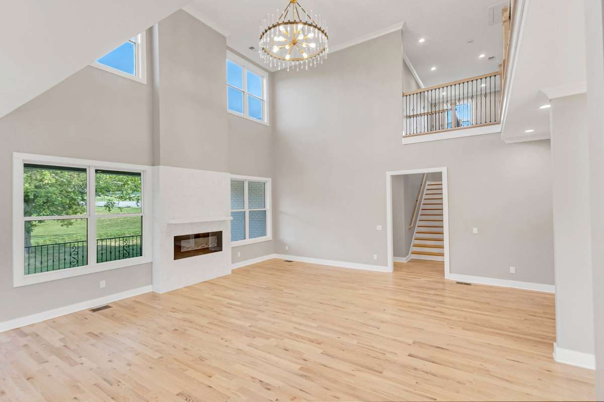 The soaring ceilings and abundant windows allow this HUGE living area to be bathed in natural light!
