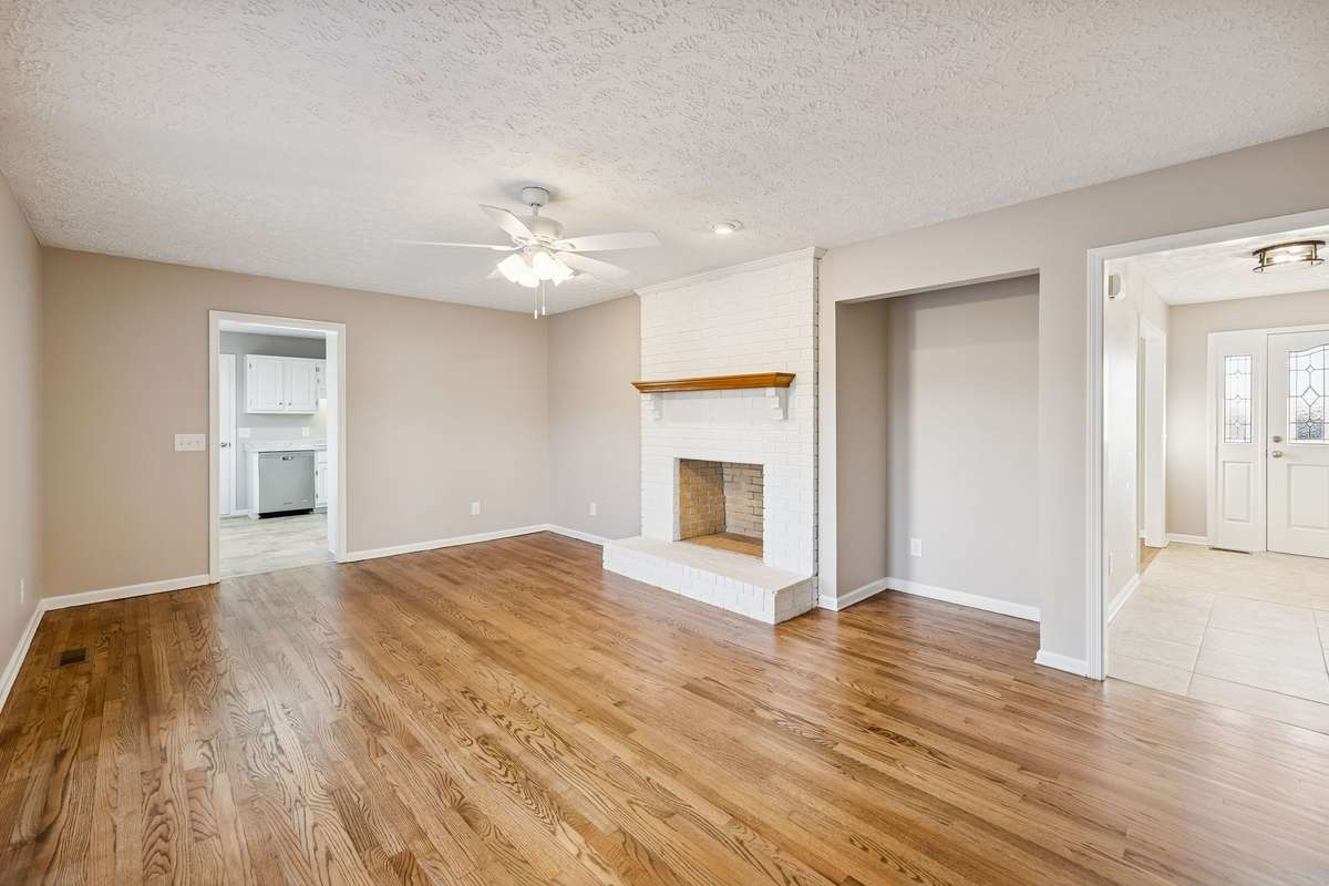 Family room with hardwood floors and wood-burning/gas fireplace..