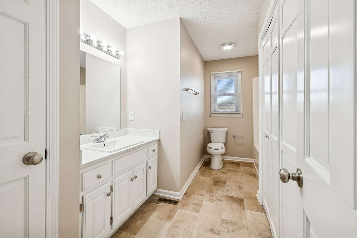 Secondary bathroom with linen closet...