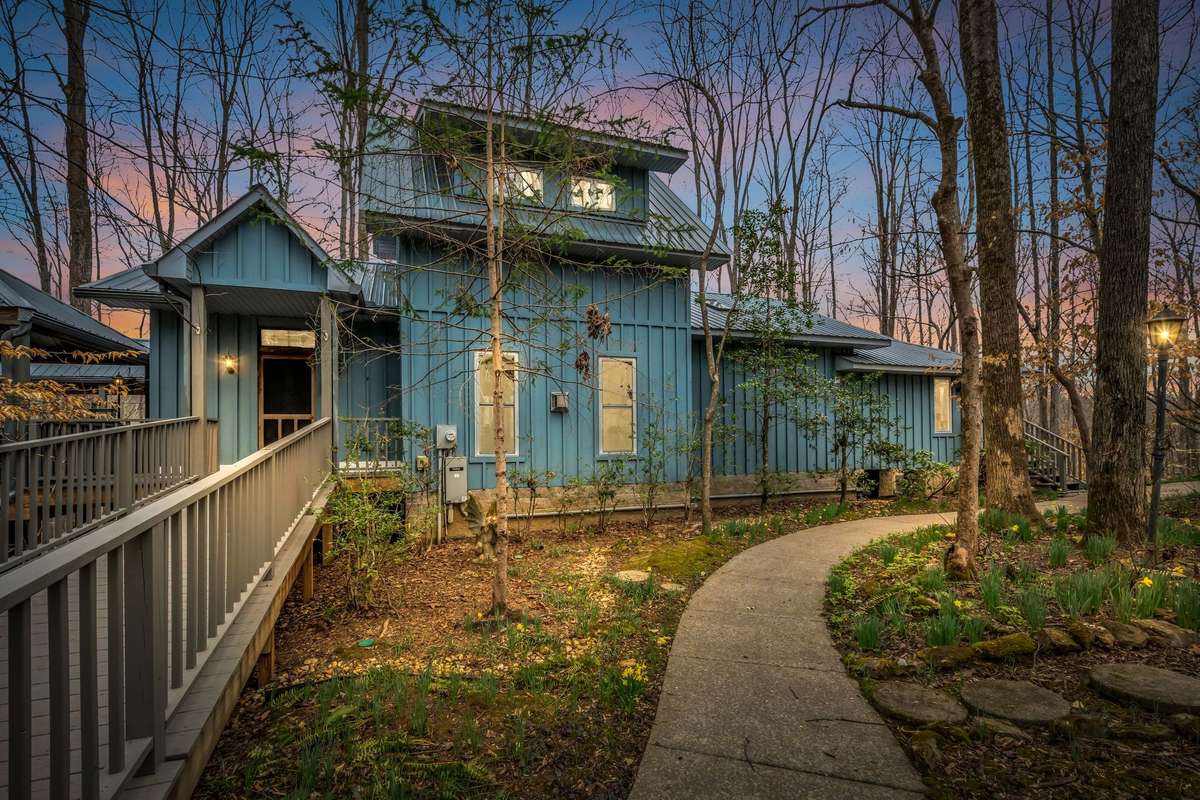 Tucked away on 6.87± acres of serene, wooded privacy, this one-of-a-kind retreat offers the perfect blend of nature, comfort, and character. A winding path leads you to a charming home surrounded by mature trees, where peace & quiet take center stage