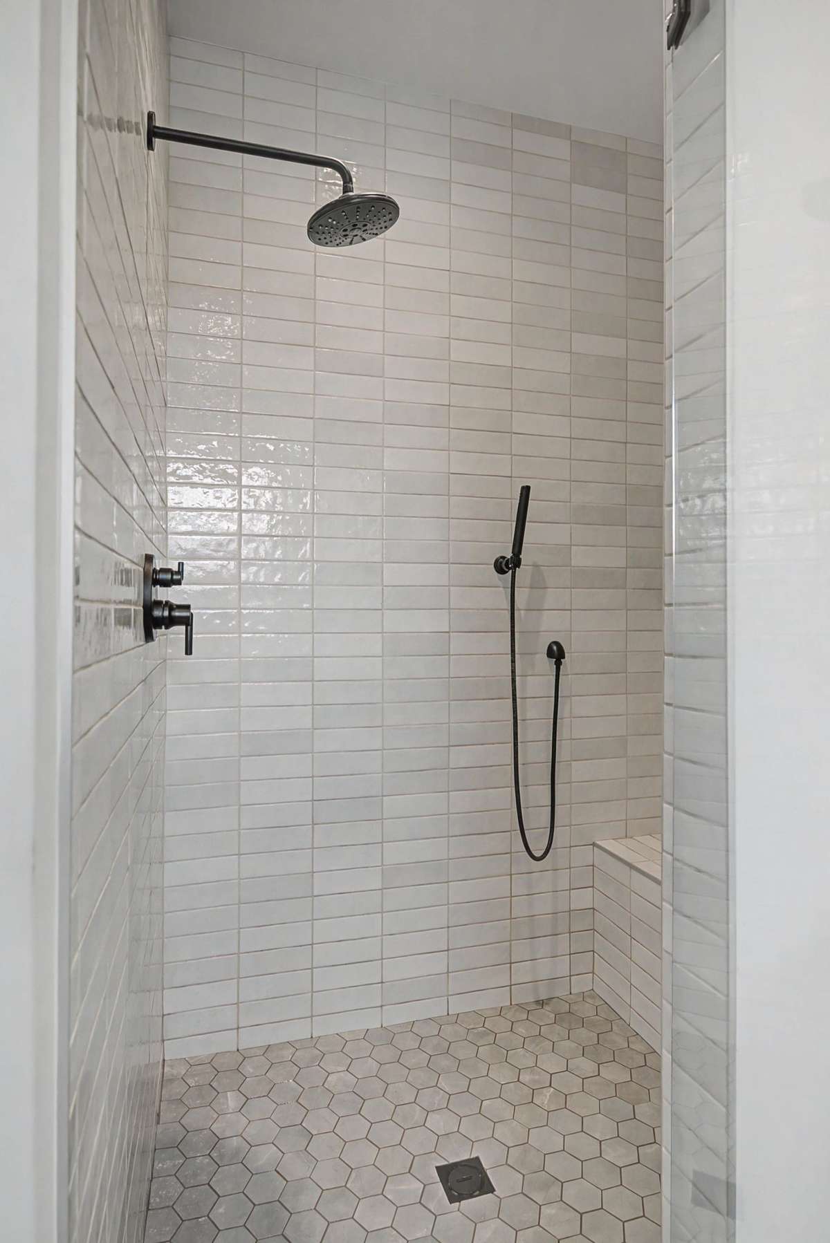 The Shower Comes Complete with a Bench and Beautiful Tiles