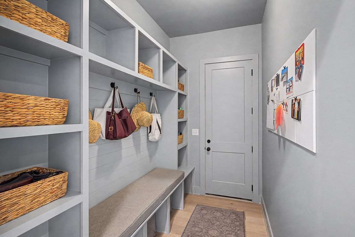 Well-Designed Mudroom Entry From the Garage Featuring Ample Storage and a Built-In Bench