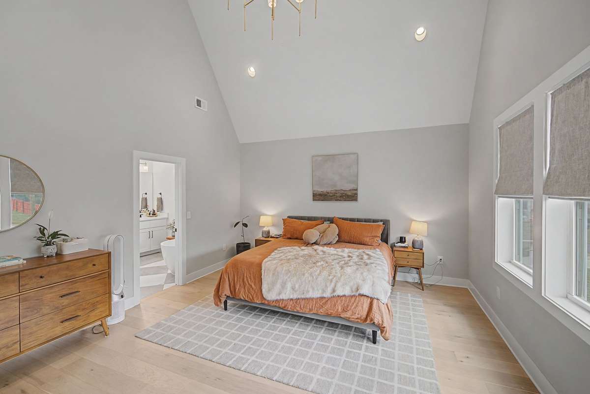 Soaring Ceilings and Expansive Windows Cap Off This Beautiful Primary Bedroom