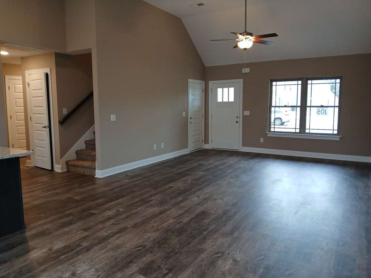 Spacious Living Room has Upgraded Plank Flooring and a Vaulted Ceiling.