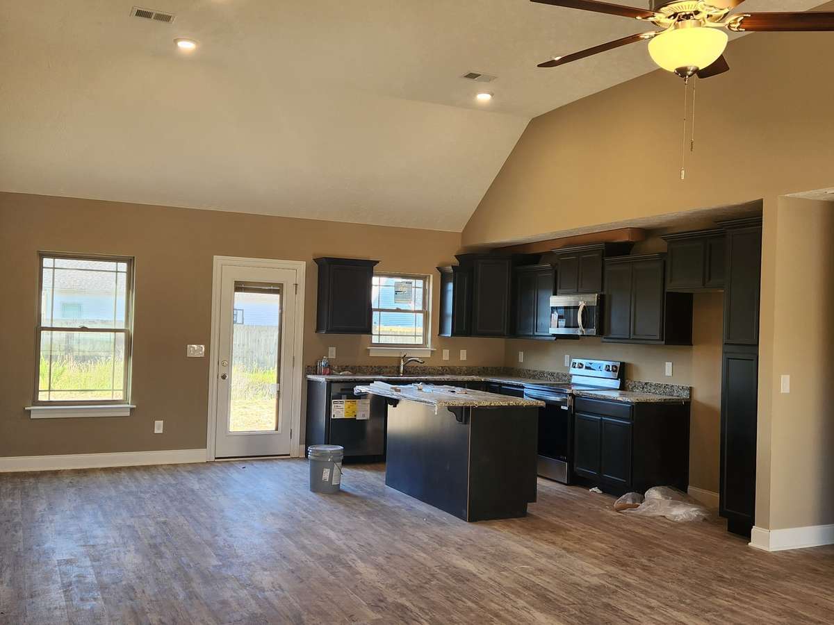Kitchen features Custom Cabinets and Granite Counter Tops.