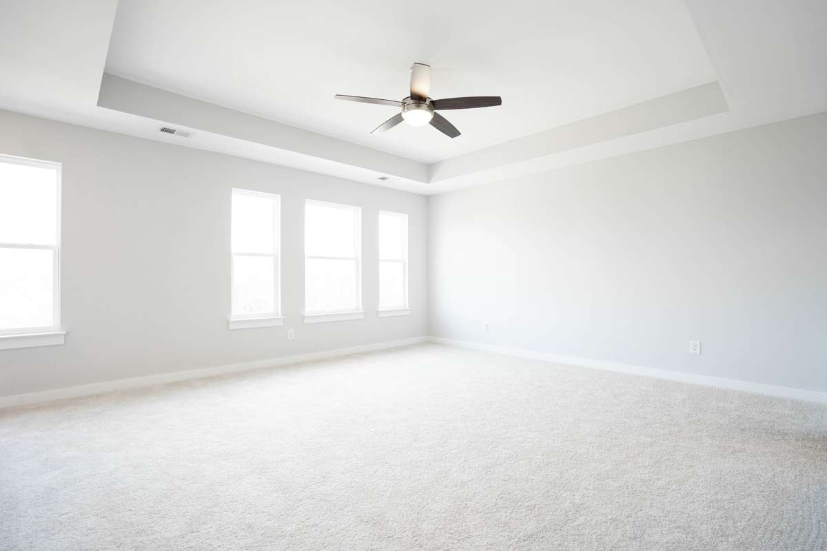 Massively large Primary bedroom with beautiful tray ceiling and fan