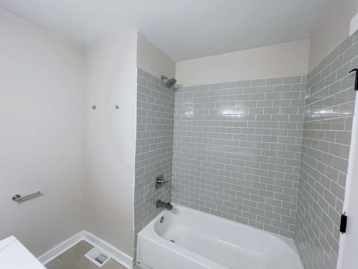 New Hall Bath with Tile Surround  and Tile Floors.