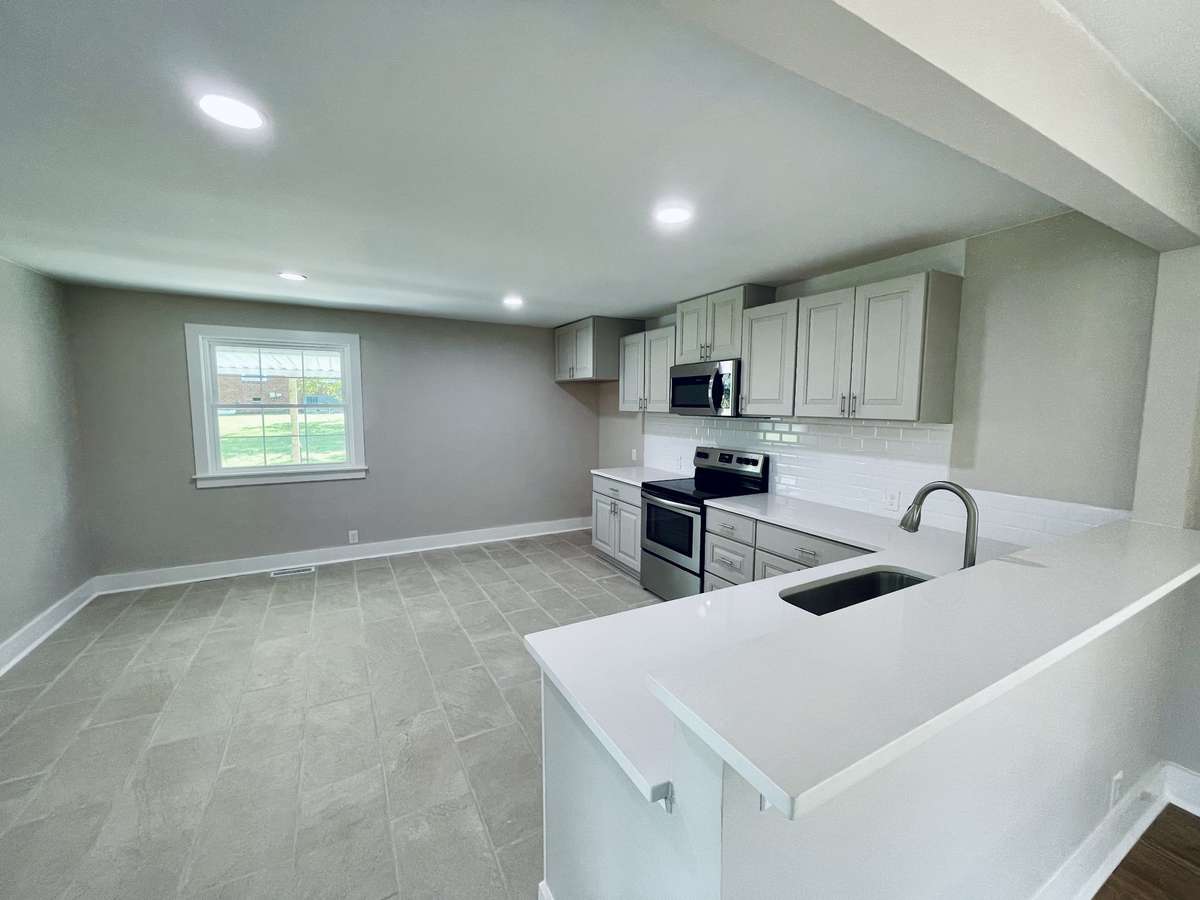 New Custom Kitchen with Tile Floors and Granite Counter Tops and Bar area.