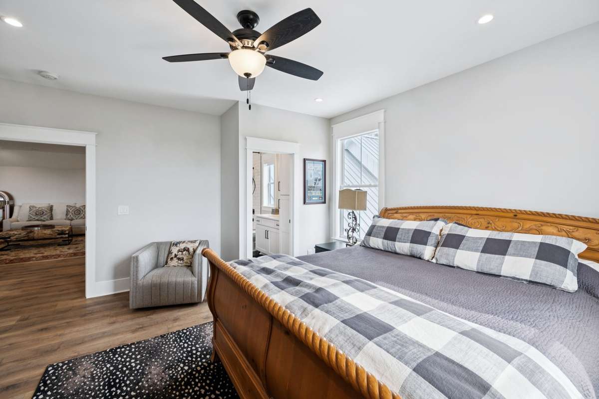 Spacious secondary bedroom with hardwood floors, recessed lighting, and direct access to a full bath. Bright, neutral finishes and generous layout make it ideal for guests or family.