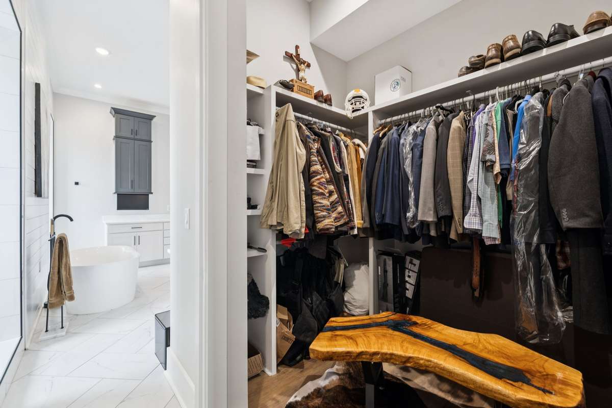 Second walk-in closet in the primary suite offers additional custom shelving and generous hanging space. Designed for optimal organization, this added storage enhances both function and convenience.