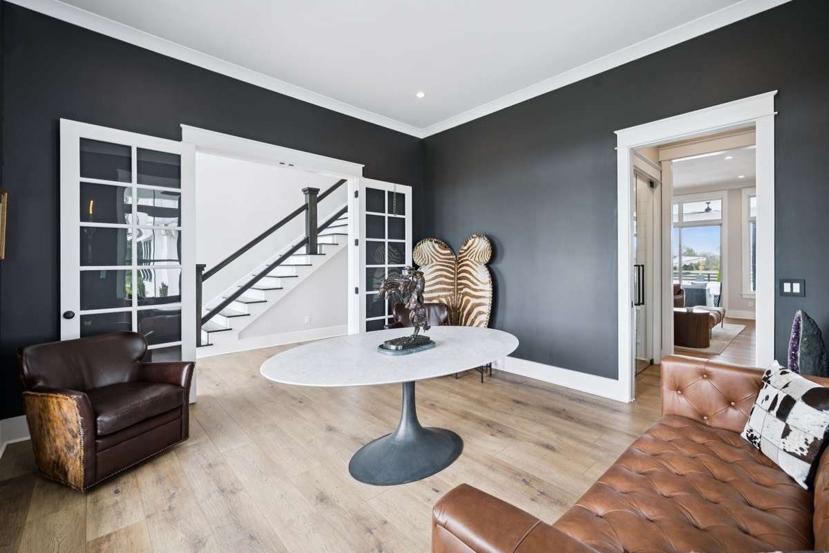 Versatile formal dining room with dramatic accent walls and abundant natural light. Ideal for hosting gatherings or easily converted into a private home office, sitting room, or creative workspace to suit your needs.
